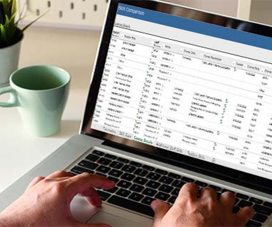 Spreadsheet data output being viewed on a laptop screen.