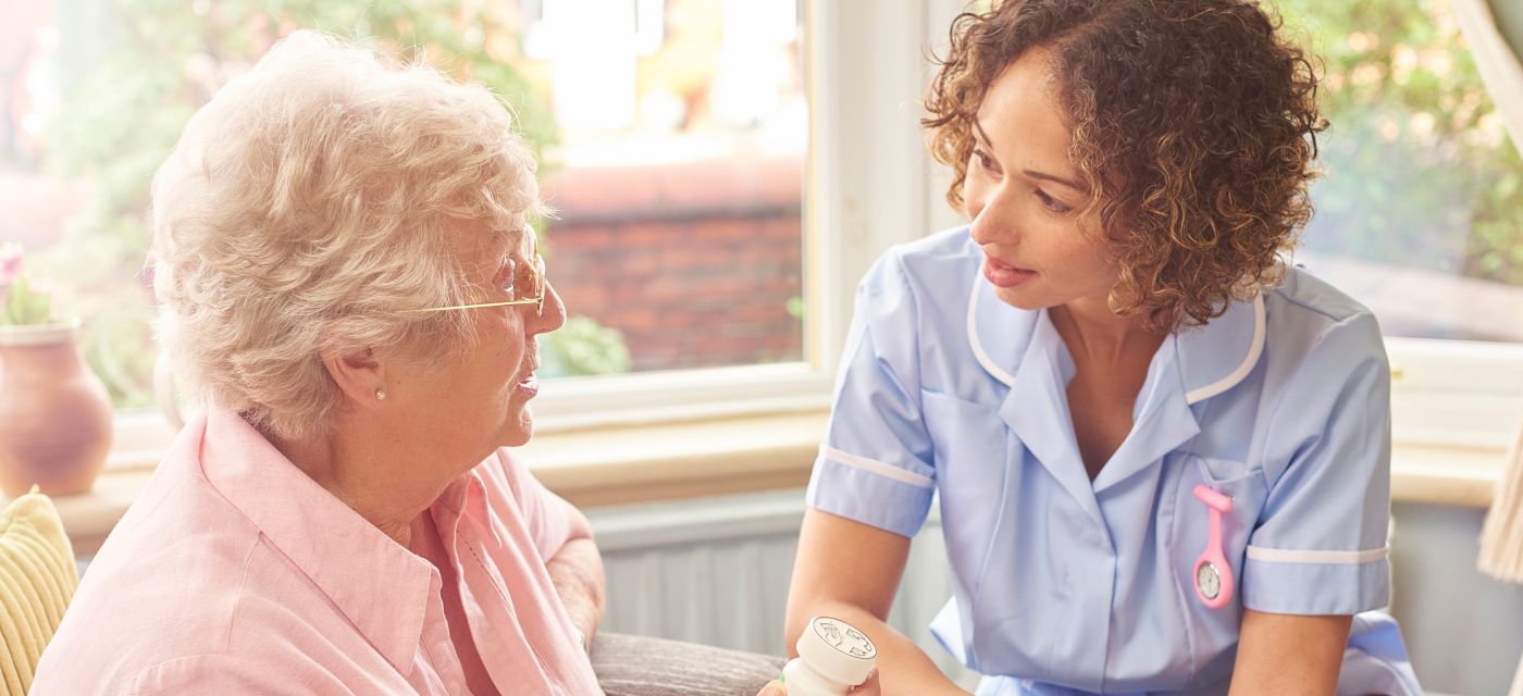 Carer interacting with an elderly resident, deep in conversation.